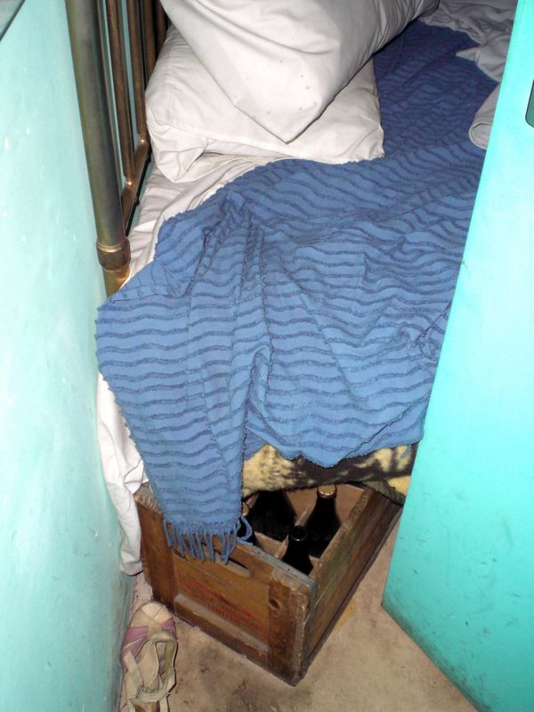 Hiding beers under the bed in a shebeen