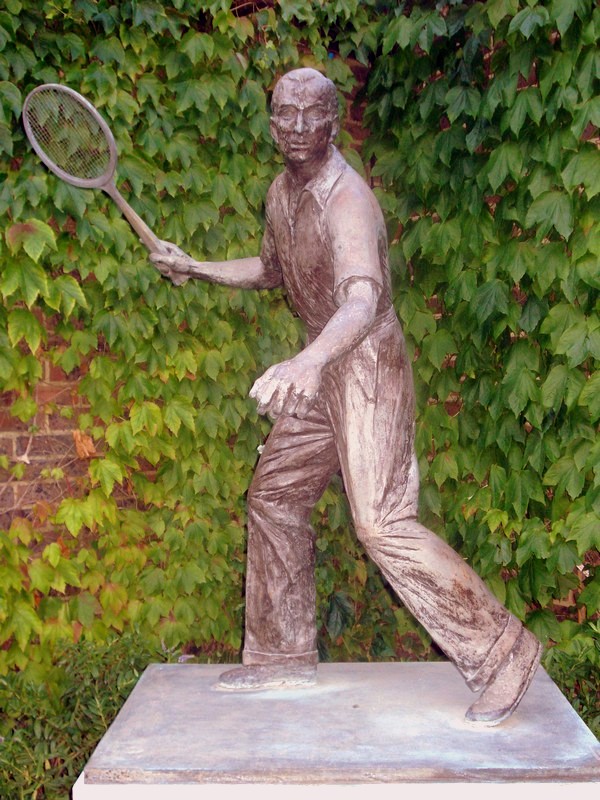 Some old guy playing tennis in a funny costume